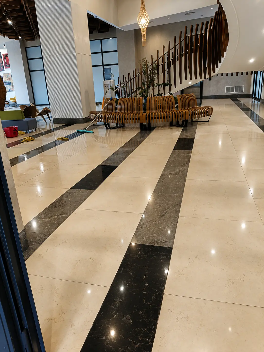 Large commercial lobby with contrasting marble bands after floor polishing