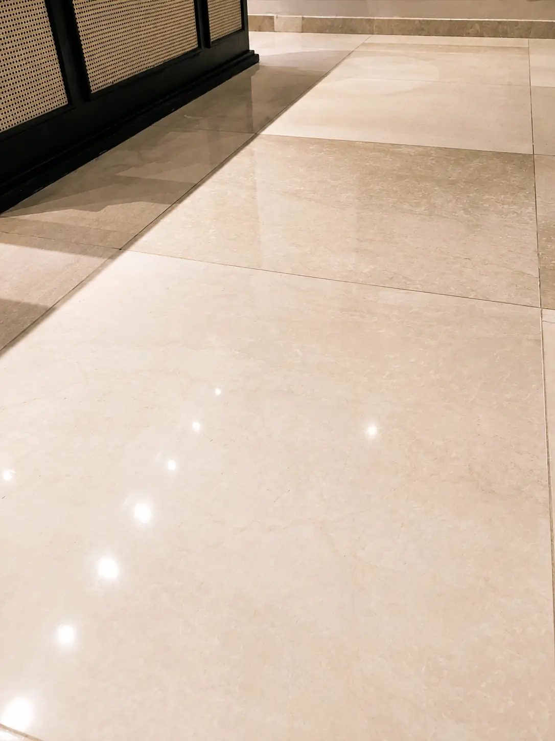 Close view of a beige marble floor with clean joints and balanced gloss