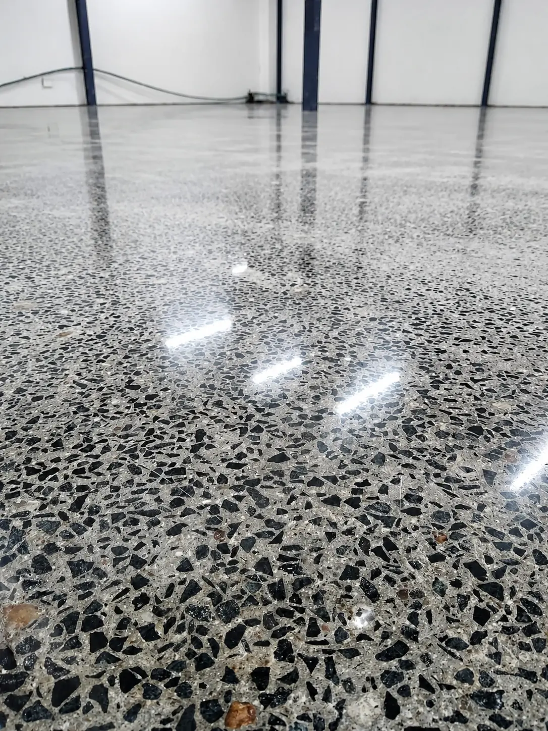 Polished concrete floor showing deeper aggregate exposure in a bright interior
