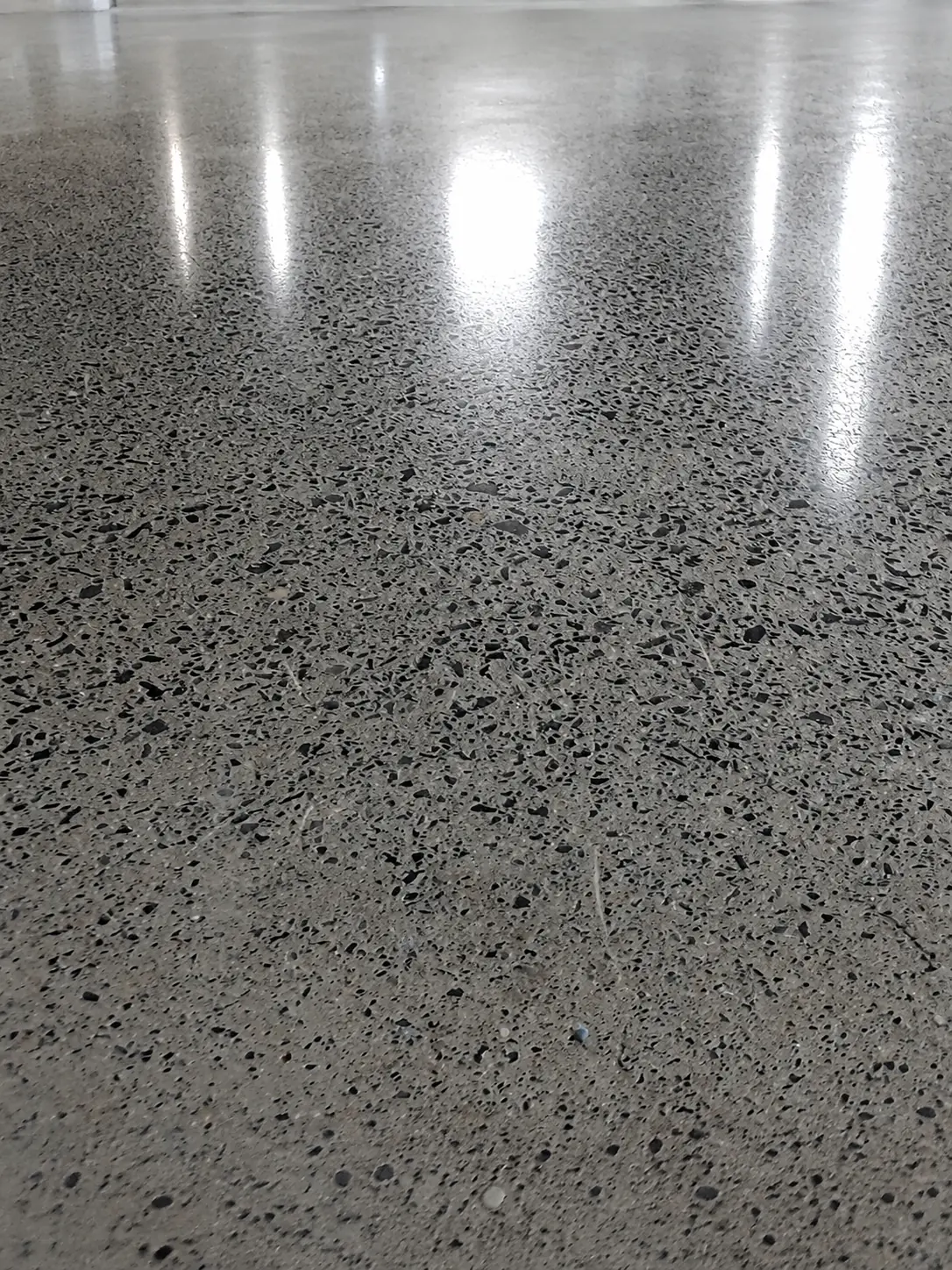Reflective polished concrete floor prepared for heavy commercial use