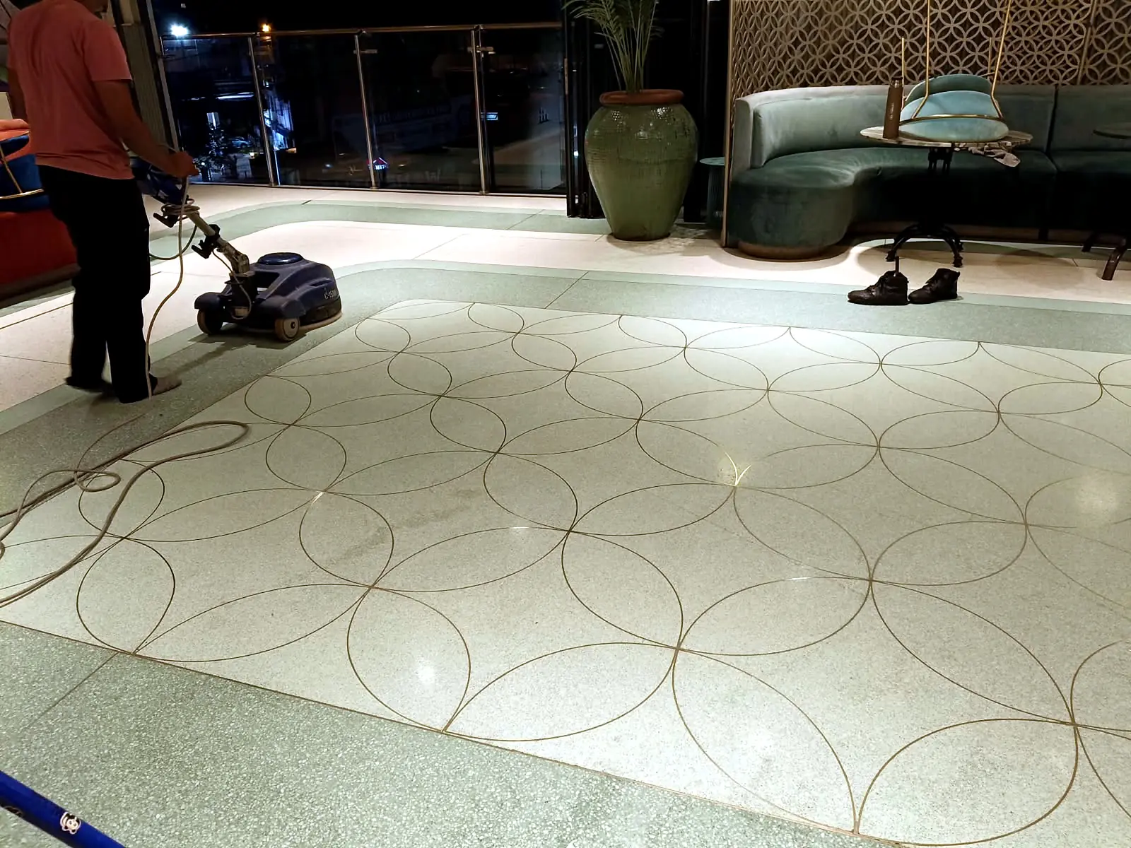 Decorative terrazzo hospitality floor during machine polishing